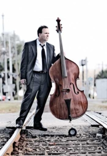 Photo of Tom Hamilton, with his base on railroad tracks.