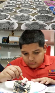 Photo of child with ceramics.