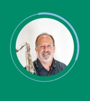 Headshot of John Wilkins, Jazz Musician, pictured with his saxophone.