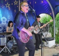 Al Lopez Band on stage performing.